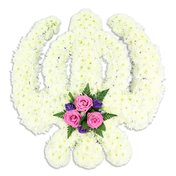 This image presents a carefully crafted Sikh Khanda floral tribute, photographed against a spotless white backdrop so that every detail of the design is clearly defined. The entire sacred emblem-the upright central Khanda sword, the surrounding Chakra circle, and the elegantly curved crossed Kirpans-has been formed from densely packed white chrysanthemum florets. Each bloom is uniform in size, giving the piece a smooth, cushioned appearance, as if the symbol has been carved from soft ivory. The petals overlap gently, catching the light and creating subtle shadows that bring out the three-dimensional shape of the swords and circular frame. There are no visible stems or gaps, only a continuous field of white that suggests purity, faith, and serenity. At the bottom centre of the tribute, resting where the blades meet, a contrasting posy adds a quiet note of colour. Three blush-pink roses are arranged closely together, their velvety petals just beginning to open, framed by several deep purple flowers and textured fern fronds in rich green. This colour combination adds warmth and emotional depth without disturbing the overall calmness of the design. The tribute has the poised, formal presence of an arrangement created for a Sikh funeral, cremation, or memorial gathering, perhaps for a service held in and around Oxford's diverse neighbourhoods such as East Oxford, Botley, or Jericho. One can imagine a local family asking an experienced florist in Oxford to prepare this piece as a final gesture of respect, its timeless white and gentle pastels offering comfort and a sense of spiritual continuity during a time of farewell.