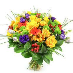 A lavish, hand-crafted bouquet is photographed against a crisp white backdrop, its vibrant colours and varied textures immediately evoking the feel of a bustling Oxford flower stall on a market morning. The design is compact and rounded, almost like a sphere of petals and foliage, with every space thoughtfully filled. Yellow tones dominate the arrangement: classic yellow roses with beautifully furled centres nestle beside plump, daisy-like chrysanthemums and smaller yellow blossoms, all glowing like afternoon light on Broad Street. Interwoven among them are clear, tangerine-orange gerbera daisies and petite orange daisies, their bold petals radiating outwards and adding a playful, upbeat mood, perfect for an uplifting delivery to Cowley or Headington. Deep purple lisianthus flowers curl gently open, each one reminiscent of a small, delicate rose, providing cool contrast and visual depth. Bright lime-green button chrysanthemums pop from between the blooms, their rounded forms and crisp colour giving the design a modern, almost sculptural detail. Here and there, gleaming clusters of ruby-red hypericum berries peek out, offering a glossy, bead-like texture that hints at celebration and special moments. Fine blades of ornamental grass arc and weave through the bouquet, creating lines of movement that draw the eye upwards, while a strong base of dark green, slightly waxy leaves holds the composition together and conceals the carefully tied stems beneath. The bouquet feels light-hearted yet elegant, as if created to mark a happy announcement, a housewarming near Port Meadow, or a thoughtful 'just because' gift for someone who loves the vibrancy of seasonal flowers.