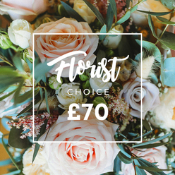 This intimate overhead image presents a softly luminous bouquet that feels almost dreamlike, where cultivated elegance meets a touch of gentle wildness. The arrangement centers on large roses in pale blush, creamy ivory and a soft peach that unfurl in generous, silk-like spirals; intermingled are quieter lavender-grey roses that lend a muted, romantic shadow to the composition. Delicate sprays of tiny white filler blossoms and little pink berry clusters float through the arrangement like a delicate mist, while dried cream grasses and tan seed heads create a warm, tactile undercurrent that deepens the bouquet's silhouette. Eucalyptus leaves with their distinctive rounded shape and dusty blue-green hue weave throughout, adding cool contrast, a hint of resinous scent and architectural movement. Soft daylight catches the petals' textures and the dried stems' feathery edges, producing a tranquil, restorative atmosphere reminiscent of a stroll by the Cherwell or a pause in the Covered Market on a spring morning. A translucent white square frames the floral center and carries a refined script announcing Florist Choice, with CHOICE in clean uppercase sans-serif beneath and the price clearly marked as £70 in strong type. The overall impression is one of considered abundance and tender craftsmanship, an artisan bouquet that reads as the thoughtful selection of a florist - perfect for marking a birthday, celebrating a new home in Jericho, or for sending a subtle, elegant note of affection across Oxford.