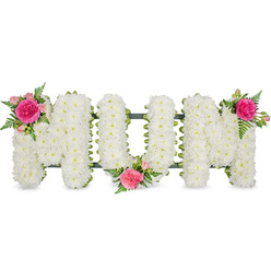 A carefully composed floral tribute spelling MUM is displayed against a clean white studio background, the simplicity of the setting allowing every petal and curve to stand out. The three capital letters, shaped in classic block style, are densely paved with small white spray chrysanthemums, each bloom pressed closely to the next so that no gaps interrupt the snowy surface. Their rounded, velvety heads form a thick, cushion-like texture that suggests comfort and purity, much like the calm that can settle over Oxford's Botanic Garden early in the morning. Beneath the blossoms, a dark green frame and ribbon can be glimpsed at the base of each letter, anchoring the arrangement and adding a subtle band of colour. To soften the crisp white, the florist has placed luxurious accent clusters at three key points: at the top left of the first M, at the gentle dip in the lower centre of the U, and at the top right of the final M. Each cluster contains a bold fuchsia rose surrounded by paler pink spray roses and tight rosebuds, woven through with feathery green fern leaves that trail lightly over the chrysanthemums. The interplay of bright pinks, fresh greens, and calming whites creates a tender composition, evoking memories of a much-loved mother. This is the kind of personalised funeral tribute families around Oxford might request for a service in Headington or Summertown, a floral message of devotion and farewell designed to rest near the coffin or be placed later at a graveside.