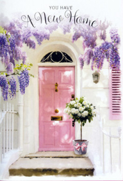 This image captures an inviting Oxford doorway that seems to breathe out a message of welcome and fresh starts. A pale pink front door, painted in a soft, milky shade reminiscent of the pastel townhouses near the Iffley Road, stands at the centre. It is framed by cascades of wisteria, their drooping clusters of lavender, lilac and cool purple blossoms tumbling from above and trailing along the white wall like a natural garland. The wisteria's blossoms look almost velvety, and you can almost imagine their sweet, powdery fragrance drifting down as bees hum nearby. At the base of the door, resting neatly on the stone step, sits a stylish grey metal bucket overflowing with white and cream roses. Each rose head is full and rounded, petals layered like soft satin, accompanied by delicate green foliage that brings a lift of freshness to the pale palette. Around the bucket's middle, a blush-pink ribbon has been tied into a gentle bow, echoing the colour of the painted door and pulling the composition together with a quiet sense of harmony. The light appears to be late afternoon, casting soft, slanting shadows across the step and catching the edges of the blooms so they glow. The overall mood is serene and hopeful, as if someone in Oxford has just moved into their new home near University Parks and been greeted with this thoughtful floral surprise. It feels like the kind of arrangement a caring local florist would choose for a housewarming, a visual blessing that whispers, "welcome home" with every petal.