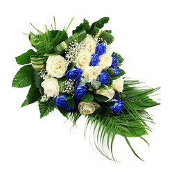 A sophisticated blue and white funeral spray stretches diagonally across a stark white background, its elongated form tapering to a graceful point that suggests a gentle bow of farewell. The central focus is a harmonious gathering of fully opened roses, their petals unfurling in layers of softness. Deep sapphire blue roses, almost luminous in tone, are evenly interspersed with creamy white and ivory roses, creating a serene rhythm of colour that feels both modern and timeless, much like the blend of old and new architecture around central Oxford. Tiny white gypsophila, or baby's breath, peeks out from the spaces between the roses, adding an airy, cloud-like texture that softens the more structured blooms. Surrounding this heart of roses is a lush collar of foliage: broad, polished dark green leaves provide depth and visual weight, while airy, bright green ferns lift the eye towards the upper left edge of the spray. From the lower right, long palm fronds sweep downward and outward, defining a teardrop or crescent outline often chosen for memorial tributes and celebration-of-life ceremonies in local Oxford chapels. Small hints of bluish-green foliage, similar to eucalyptus, nestle between the flowers, offering subtle variation in shape and tone. Carefully folded leaves, arranged into neat green-and-cream bands, coil through the design like ribbons, revealing the florist's attention to detail. The overall mood is quiet and contemplative, ideal for a sympathy arrangement delivered to a funeral home or resting chapel, expressing respect, remembrance, and a sense of enduring love from family and friends across Oxford.