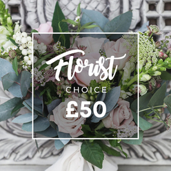 There is a gentle serenity to this bouquet that reads like a short, fragrant poem in pale pinks and silvery greens, the sort of arrangement we make at Flowers Oxford after a morning visit to the Covered Market. Pale blush roses form soft, rounded centres, their petals unfolding with a tactile velvet quality, while smaller white blooms - possibly lisianthus or tiny spray roses - float between the larger heads, adding lightness and nuance. Dusty blue-green eucalyptus leaves arc through the design, their cool, herbal scent lending a calming undercurrent to the composition. Clusters of bright white berries, likely snowberries or hypericum, add crisp punctuation, and delicate sprays of tiny white waxflower or similar filler create an airy texture that breathes between stems. A few deeper pink or burgundy accents nestle low in the arrangement for depth, and slender green-and-white flower spikes peek at the edges, giving a hint of height and direction. The bouquet is hand-tied with a cream-coloured ribbon, finished with visible, comfortably gathered stems - the kind you might carry home from a riverside stroll along the Cherwell. In the photograph a soft ambient light highlights the petals' subtle gradients and the eucalyptus' silver sheen; a white rectangular overlay reads "Florist Choice" with a price of "?50," indicating a thoughtfully curated, seasonal selection. This piece conveys understated refinement and warmth, perfect for sending congratulations, a bedside cheer, or a 'thinking of you' surprise with same-day delivery across central Oxford and neighbouring areas.