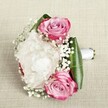 Cradled gently against a textured, flaxen background that evokes Oxford's artisan workshops and tranquil riverside walks, this bouquet invites the senses with its quietly romantic composition. Three striking pink roses-each petal a blend of vibrant fuchsia edging that yields to blush-pink and silken lavender at the heart-are carefully woven amongst a billowing white peony, its frilled petals conjuring the soft, pillowy clouds drifting above Christ Church Meadow. Wisps of baby's breath lace effortlessly through the arrangement, imbuing the bouquet with a delicate, fairy-tale softness and a gentle, almost powdery presence, much like the scent of spring in Oxford's historic gardens. Framing the blooms, deep emerald-green leaves-shaped into a sleek, encircling collar-provide both structure and a fresh, dewy vibrancy. The bouquet's hand-tied handle, ensconced in smooth white satin, signals the craftsmanship and loving attention of a local Oxford florist. Dappled, even light washes over the scene, enhancing every fold and colour variation, transforming the bouquet into a dreamlike celebration of hope and affection. This arrangement is more than a floral accessory-it's a poetic gesture for weddings, anniversaries, or heartfelt moments on the cobbled streets and leafy avenues of Oxford, delivered with care and timeless style.