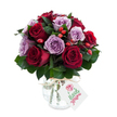 A lush, hand-tied bouquet of roses arranged into a dense, rounded dome: deep crimson and burgundy blooms sit cheek-by-jowl with soft lavender and dusty purple roses, each flower freshly opened with layers of unfurling petals that read velvety to the touch. Dark, glossy greenery - the broad, supportive leaves of Ruscus or Salal - nestles between the roses, giving the composition depth and a cool, leafy backdrop that makes the reds and mauves sing. Bright red-orange rose hips or small berries are dotted throughout like tiny lanterns, adding a rustic, textural surprise against the smooth rose faces. The flowers are seated in a rounded mercury-style glass vase, its antique silvered, crackled finish catching and scattering the light; the bulbous base tapers gently toward the neck, where a loop of natural raffia or twine is tied for a simple, homespun accent. A small rectangular white gift tag tilts forward from the raffia, marked with a delicate hand-drawn rose illustration and room for a personal note, while the whole arrangement is set against a brilliant white background that sharpens every colour and reflective glint. I picture this bouquet delivered to a bright flat near the Oxford Covered Market or laid on a kitchen table after a walk along the Cherwell: romantic but quietly grounded. The scent is imagined as soft and floral, the petals cool and satiny beneath your fingertips, the berries giving a lively, almost autumnal tang. This arrangement reads as an intimate, thoughtful gift - equally at home for an anniversary, a sincere thank-you, or simply to brighten someone's day in central Oxford or a nearby neighbourhood like Jericho or Summertown.