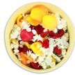 A round, creamy-yellow ceramic bowl sits under soft, even light, seen from directly overhead so that its entire interior becomes a canvas of petals. Inside, thick, velvety rose petals in deep crimson red cluster beside bright yellow and mellow peach-apricot tones, their edges gently curled and layered in organic, overlapping shapes. Between these bolder petals, countless small white hydrangea-like florets weave through the mixture, their finely textured, almost feathery forms offering a calm, pale contrast that lightens the arrangement. The bowl is generously packed so that the petals reach right to the rim, suggesting both abundance and a loving, hand-gathered touch, as if they have just been prepared in the workroom of an Oxford florist off Cowley Road. The lighting is bright yet soft, highlighting the subtle differences in texture-from the satin smoothness of the roses to the delicate, papery feel of the white blooms-without casting harsh shadows. The palette of red, yellow, and white carries a quiet symbolism well suited to a funeral or memorial tribute: passionate love, gentle remembrance, and peaceful rest. You can imagine these petals being lifted from the bowl and scattered in a slow, dignified gesture at a service near Christ Church Meadow or along a favourite riverside walk. Though simple in form, the image speaks of care, respect, and the comforting rituals of farewell that flowers bring to families throughout Oxford, turning grief into a moment of soft, fragrant beauty.