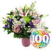In this celebratory image, a lavish floral display in a contemporary pink vase is paired with a bright foil balloon to honour a 100-year milestone. The background is a clean, uninterrupted white, allowing every petal and leaf to stand out clearly, much as one might see it arranged for a special delivery across Oxford, from Summertown to Cowley. The vase, a soft matte blush-pink with gentle vertical ribbing, cradles a dense and carefully crafted bouquet. At the heart of the arrangement, pale pink Oriental lilies stretch upwards, some already open to reveal wide, star-shaped blooms and prominent stamens dusted with pollen, others closed in elegant buds that speak of days ahead. Nestled around them are soft pink and muted mauve roses, their cupped forms adding depth and a timeless romantic note. Threaded through the roses are deep purple lisianthus and sprigs of lavender-toned asters, each tiny daisy-like flower centred with yellow that suggests sunlight. Sharp accents of lime green button chrysanthemums provide a modern, playful contrast, while delicate clouds of white baby's breath lighten the whole composition. Various glossy dark green leaves frame and support the flowers, adding structure and the feel of freshly gathered foliage from a local garden. Just touching the lower right of the bouquet, a shining round foil balloon brims with confetti-style dots in vivid primary and secondary colours. Dominating its centre, the bold white numerals 100 appear with a gentle three-dimensional effect, immediately signalling a centennial celebration. The overall impression is joyful and respectful, a fitting tribute to a 100th birthday, a long-lived marriage, or an Oxford community or college marking a full century of stories.