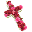 Captured against a luminous white background, this impressive floral cross appears almost to float, its sacred outline completely shaped by roses and delicate white blooms. The main body of the Latin cross is lavishly filled with deep red roses, each blossom fully open and velvety, their petals curling outward in generous spirals that convey respect, devotion, and profound grief. Threaded through these are clusters of vivid fuchsia pink roses and buds, their softer, ruffled petals adding a tender counterpoint and suggesting cherished moments of joy remembered amid sorrow. Between the larger blooms, smaller rosebuds in matching tones create a sense of depth and gentle movement, drawing the eye from the base of the cross to the tips of the arms. Along the very edge runs a precise border of tiny white flowers - likely spray chrysanthemums or dainty carnations - that forms a crisp, cloudlike frame, accentuating the shape and lending an air of purity, peace, and blessing. Fine touches of fresh green foliage or a slim ribbon emerge subtly at the sides, giving structure and a finished, professional look typical of funeral tributes created for services in Oxford's churches and crematoria, from central Oxford to areas like Marston and Cowley. The lighting is soft and even, with no harsh shadows, allowing the rich reds, bright pinks, and clean whites to stand in gentle harmony. This floral cross is designed as a touching funeral arrangement, ideal for memorial services, wakes, or graveside farewells in Oxford, expressing faith, remembrance, and a loving final tribute.
