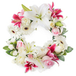 A richly detailed circular wreath of funeral flowers sits against a pristine white background, forming an open ring of blooms that feels both comforting and refined. Dominating the design are large, graceful white lilies, their broad petals unfolding like soft satin, framing golden stamens and fresh green pistils that catch the light. Threaded among these are striking deep magenta and fuchsia lilies, their star-like shapes and speckled petals adding a sense of depth, colour, and quiet drama, like a sunset reflected over the River Thames in Oxford. White gerbera daisies, each with a dark central eye, punctuate the arrangement with a clean, modern note, their layered petals adding a crisp texture against the more velvety roses and lilies. Clusters of pale pink roses mingle with creamy white roses, some in full bloom, others still in bud, suggesting cherished memories and love that continues to grow even in farewell. Between the larger flowers, small white accents-likely spray carnations, miniature roses, or tiny chrysanthemums-are carefully placed to create a seamless, cushioned effect, so that no part of the circle feels empty or unfinished. A generous fringe of varied green foliage forms the base and outer edge of the wreath, its lush leaves adding movement and a natural, garden-like feel. The overall impression is of a lovingly crafted memorial wreath, the kind a family in Oxford might choose for a funeral at a local church or crematorium, offering a message of eternal love, respect, and tranquil remembrance in a beautifully balanced floral tribute.