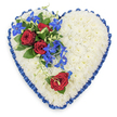 The photograph captures a generously sized, heart-shaped sympathy tribute, photographed from above to show every floral detail. At its core, the heart is entirely composed of densely packed white chrysanthemums, their many small petals overlapping to create a soft, uniform surface that suggests tenderness and serenity. The blooms form a pristine, snow-like background, unbroken and calm. Around the edge of the heart runs a royal blue satin ribbon, pleated and slightly ruffled by hand, giving the tribute a defined outline. The ribbon's rich colour and subtle shine lend a sense of formality and honour, reminiscent of thoughtful services held in Oxford churches and chapels. In the upper left portion of the heart, a prominent floral spray introduces depth and emotion: three fully opened red roses sit proudly among deep green leaves, their velvety petals rich and saturated, symbolising enduring love and respect. From this focal point, bright blue dendrobium orchids extend towards the centre and gently downwards, their star-shaped flowers and slender stems bringing rhythm and visual movement across the white chrysanthemum base. Fine, curly green tendrils weave in and around the orchids, adding a touch of softness and a natural, garden-inspired feel. On the lower right curve of the heart, a single red rose appears, paired with a small hint of foliage, echoing the main cluster and providing a quiet counterpoint that balances the design. The overall effect is of a carefully considered funeral tribute created by a local Oxford florist, well suited for expressing heartfelt condolences at services across Jericho, Cowley, or Summertown, and offering a visually powerful blend of purity, passion, and peace.