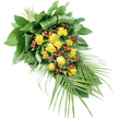 An elegant yellow rose funeral spray is pictured on a crisp white background, its form intentionally elongated to draw the eye from the fuller top left to the gently tapering tip at the lower right. This diagonal sweep creates a feeling of movement and quiet procession, echoing the tone of a respectful farewell. At the heart of the design are numerous yellow roses, approximately fifteen to twenty blooms, each with a unique personality: some are still partially closed, petals wrapped protectively around their centres, while others are open and generous, their velvety petals layered in soft golden curls. Between these roses, glossy clusters of deep red berries, likely Hypericum, add depth, contrast, and a hint of richness, much like the warming colours of Oxford's historic brickwork at sunset. The roses and berries rest on a carefully built base of green foliage. Near the top, broad, dark green leaves are layered and skilfully folded, creating a structured backing that feels both sturdy and refined, the kind of detail an experienced local florist might refine in a quiet workshop just off the High Street. From the lower right, slender, palm-like fronds and airy leaves extend outward, each leaflet narrow and pointed, adding lightness and grace to the overall shape. The stems are neatly tied together at the top, hidden under the foliage so that the spray appears seamless when viewed from above. Under gentle, diffuse lighting, the arrangement looks fresh and composed, conveying warmth, remembrance, and a sense of gentle hope, suitable for funerals, cremations, and celebrations of life held throughout Oxford.