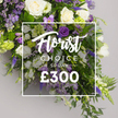From Flowers Oxford, this long, elegant funeral spray unfolds with calm gravity, designed to rest as a dignified tribute along a casket or on a pedestal at a memorial service. The palette borrows from pristine whites and deep purples, punctuated by fresh greens that give the arrangement life and movement. Ivory white roses stand at intervals, their satin petals catching the light, paired with soft lisianthus that shimmer with a porcelains-white glow, and freesia that release a subtle, comforting perfume when you near the display. The purples range from rich royal tones to softer lilacs, with tall delphinium or larkspur spires piercing upward, and lavender-hued blooms weaving through the cluster. Lush greenery-fern fronds and eucalyptus-like foliage-frames the bouquet, lending depth and a natural, cascading form that would lay smoothly on a coffin or lie as a substantial tribute on a stand. Against a soft neutral grey backdrop, the image bears an overlaid semi-transparent white rectangle containing text. The upper line proclaims 'Florist Choice Special' in an elegant flowing script, directly above a bold sans-serif price of '?300'. Delivered across Oxford neighbourhoods-from the historic streets near High Street to the quiet corners of Jericho and Summertown-this arrangement communicates reverent, heartfelt sympathy. Its craftsmanship reflects the careful eye of a local florist who values seasonal stems, scent, and the quiet dignity of remembrance, ensuring a piece that looks both regal and comforting for families during times of loss.
