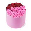 From Flowers Oxford, this luxurious and meticulously arranged floral display sits centered in a soft pink velvet cylindrical hatbox, the crisp white backdrop giving it gallery-quality presence. Dozens of fully opened roses fill the box to the brim, their petals catching light with a satin-like sheen. The blossoms are arranged in two striking colour blocks: at the top, roughly a dozen deep crimson red roses curve in a crescent that hints at a heart or a deliberate division; below, the broader lower half bursts with bright fuchsia pink roses, a lively counterpoint that glows against the pale velvet.

Each bloom wears tightly layered petals, suggesting premium fresh-cut stock or long-lasting preserved roses. The overall effect is elegant romance, ideal for Valentine's Day, anniversaries, or a sophisticated home display that elevates any dining room or foyer. In Oxford, we love crafting gifts that feel intimate yet luxurious, whether you are sending from Jericho, Summertown, or the more historic lanes near the University Parks. We offer careful, same-day delivery across the city, ensuring this centerpiece can arrive promptly for a surprise on a doorstep near the Oxford Castle Quarter or the train station. The product-shot presentation highlights the quality of the roses and the craftsmanship of the box, inviting a viewer to imagine the soft sound of petals brushing together and the gentle scent of a fresh, premium bouquet. It's more than a gift box; it's a promise of celebration, refinement, and a touch of romance that makes a home feel suddenly more special.